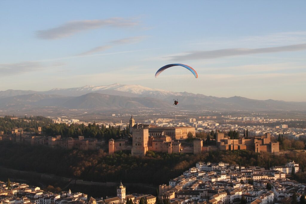 Things to Do in Granada 1 Paraglider flying over the Alhambra and the city of Granada